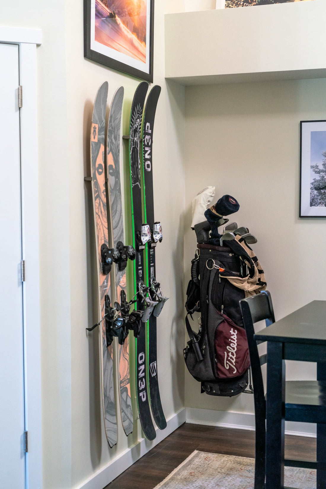 Bold Black and Green ON3P Skis on Cream Wall: Elevate Home Storage Elegance