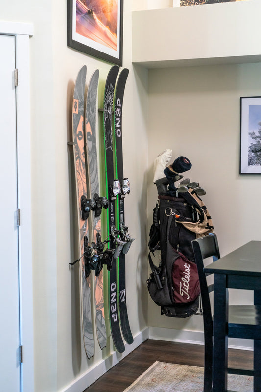 Bold Black and Green ON3P Skis on Cream Wall: Elevate Home Storage Elegance