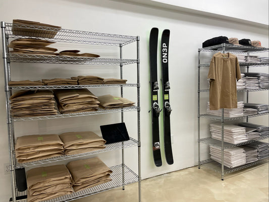 Sleek ON3P Black and Green Skis on Minimalist White Wall: A Modern Storage Showcase