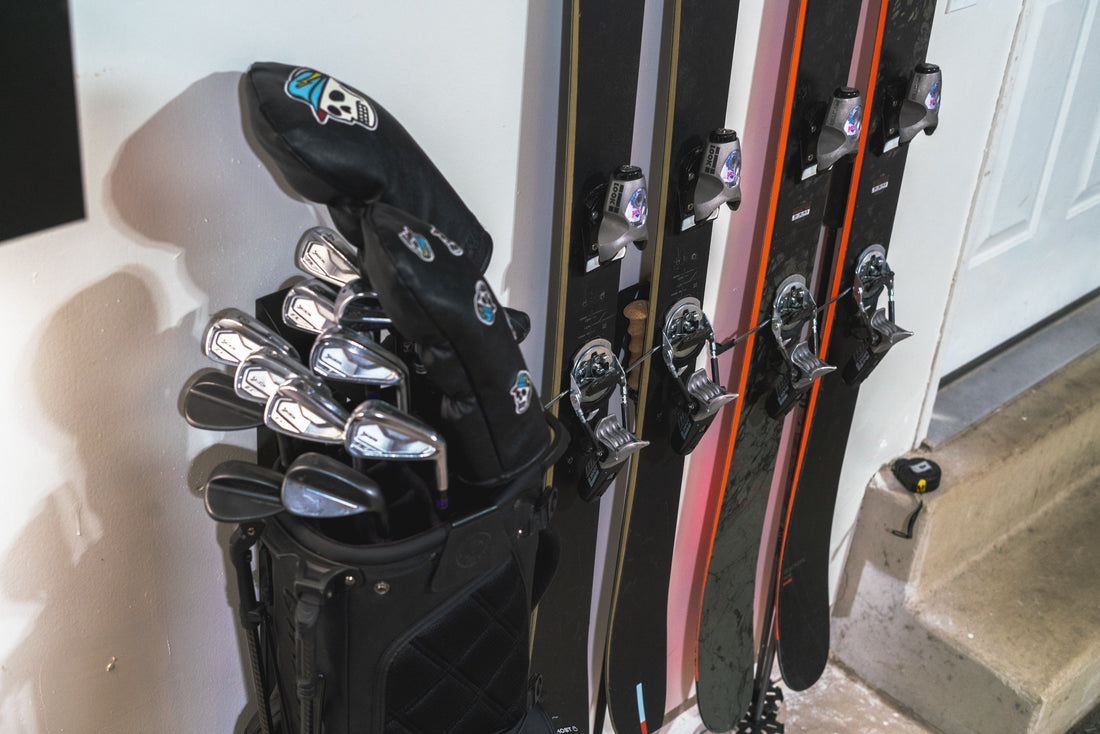 Sleek Black and Orange Skis on Modern White Wall: Hover's Storage Artistry
