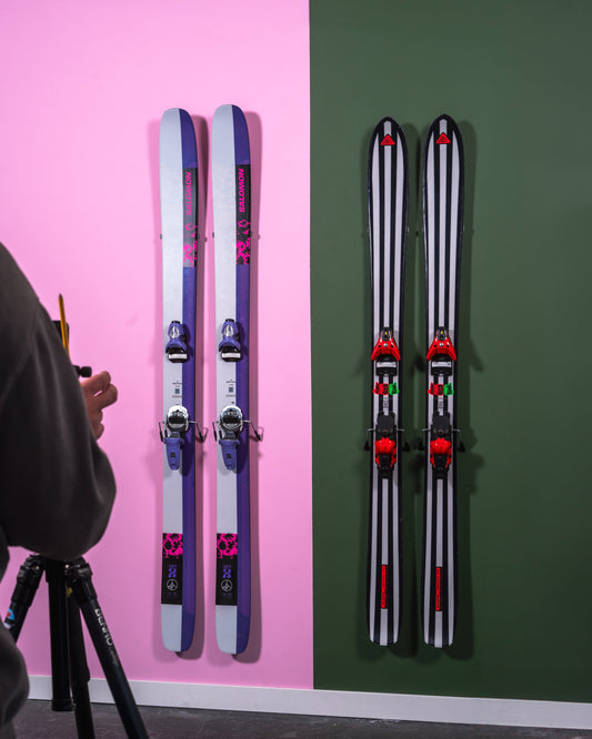 Purple and Pink Salomon Skis Against Pink and Green Wall: Elegance in Storage