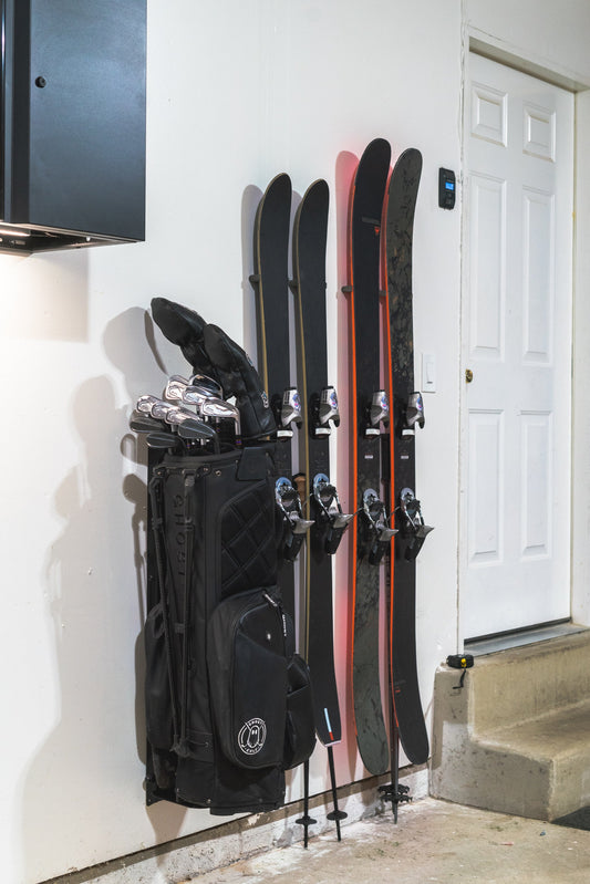 Sleek Black and Red Rossignol Skis on Pristine White Wall: Modern Elegance in Storage Design