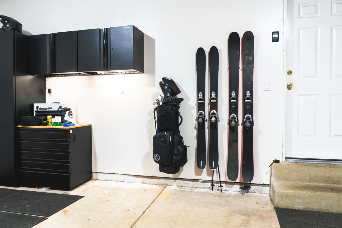 Sleek Black Alpine Skis on Pristine White Garage Wall: A Minimalist's Dream