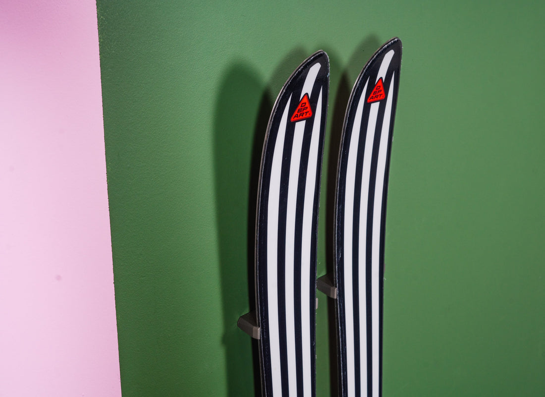 Black and White Striped Skis on Green and Pink Wall: Bold Storage Elegance