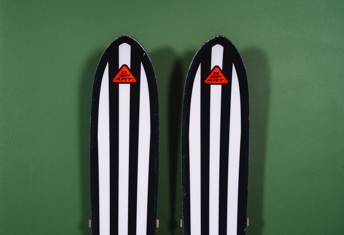 Black and White Striped Skis on Green Wall: A Modern Storage Statement