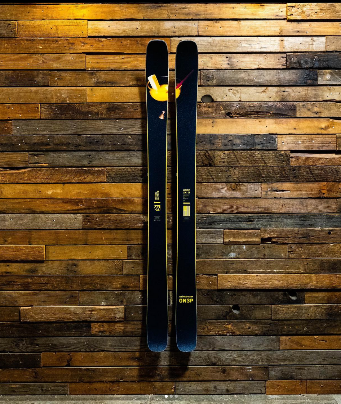 ON3P Black and Yellow Skis on Rustic Wood Wall: Bold Storage Elegance