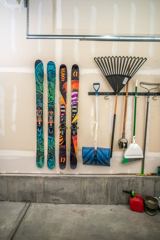 Vibrant Armada Skis on Neutral Garage Wall: Bold Meets Functional Elegance