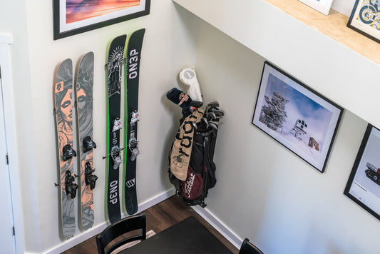 Bold Black and Green ON3P Skis on Minimalist White Wall: Artful Storage Solution