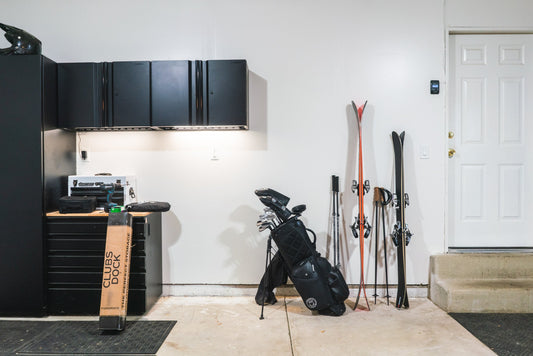 Sleek Orange and Black Skis Against Pristine White Wall: Modern Storage Elegance