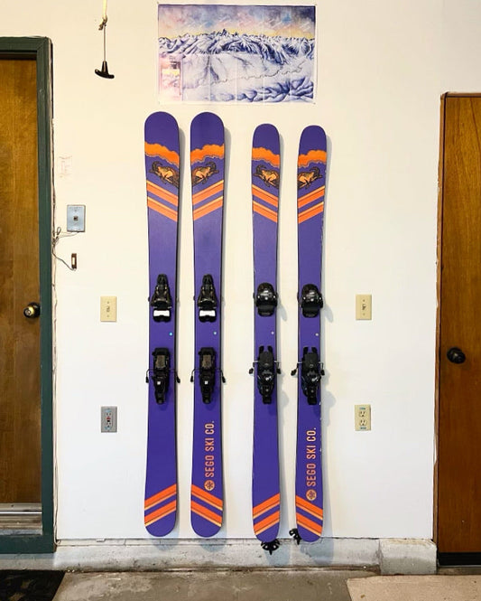 Vibrant Purple and Orange Sego Skis on White Wall: Modern Storage Elegance