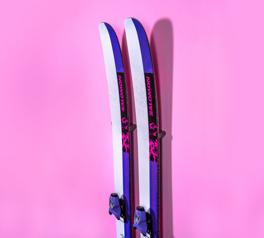Vibrant Salomon Skis in Pink and Purple on Modern Pink Wall Display