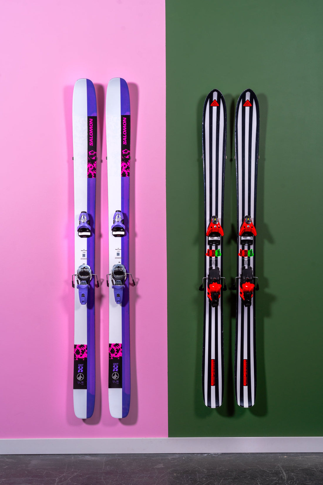 Vibrant Purple and Monochrome Striped Skis on Bold Pink and Green Walls