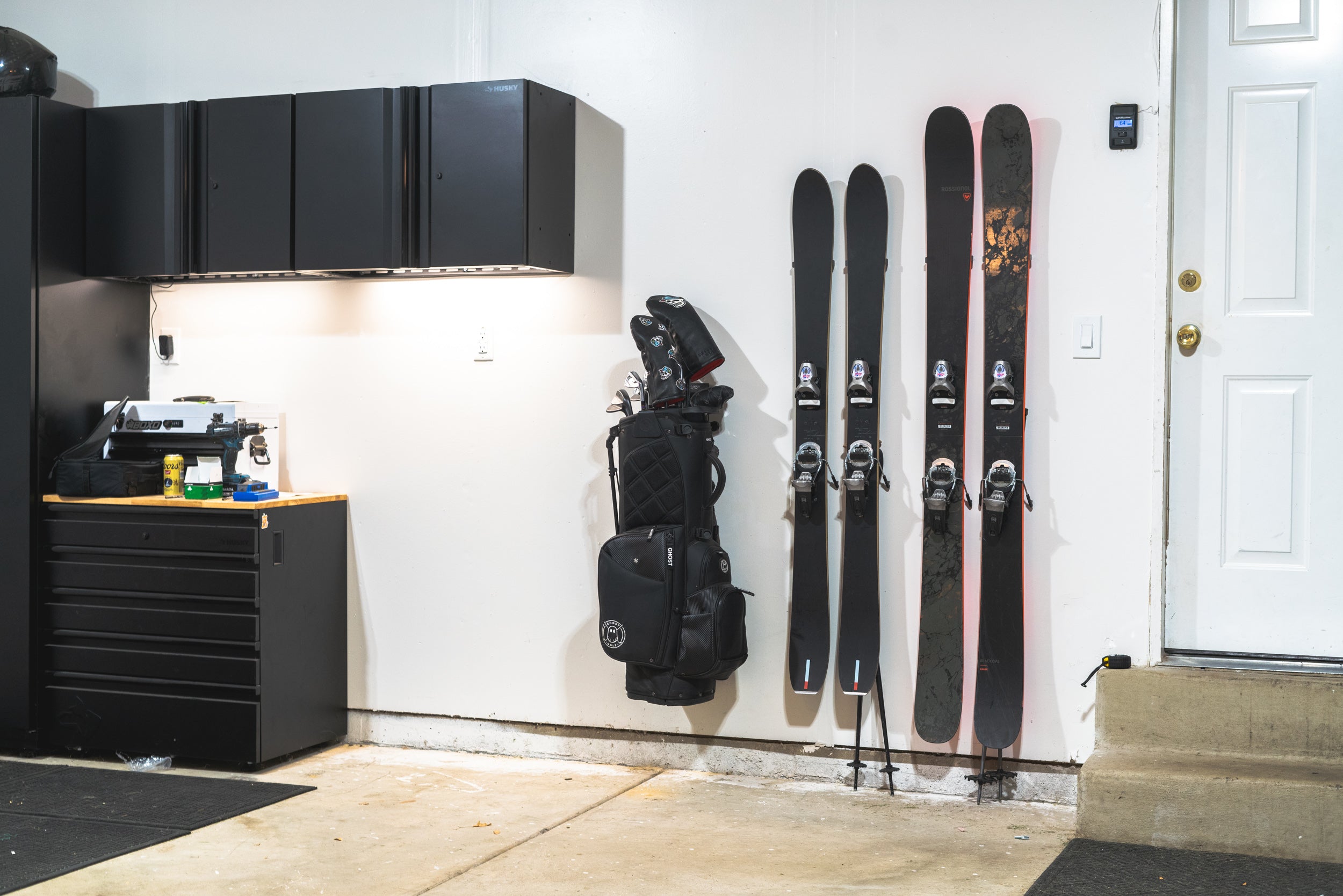 Black and red skis on Hover Equipment wall-mounted ski storage solution